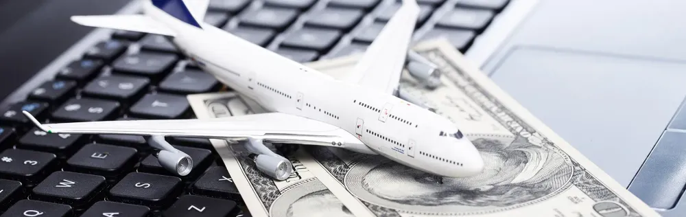 Airplane and Cash on Keyboard Airline Fees